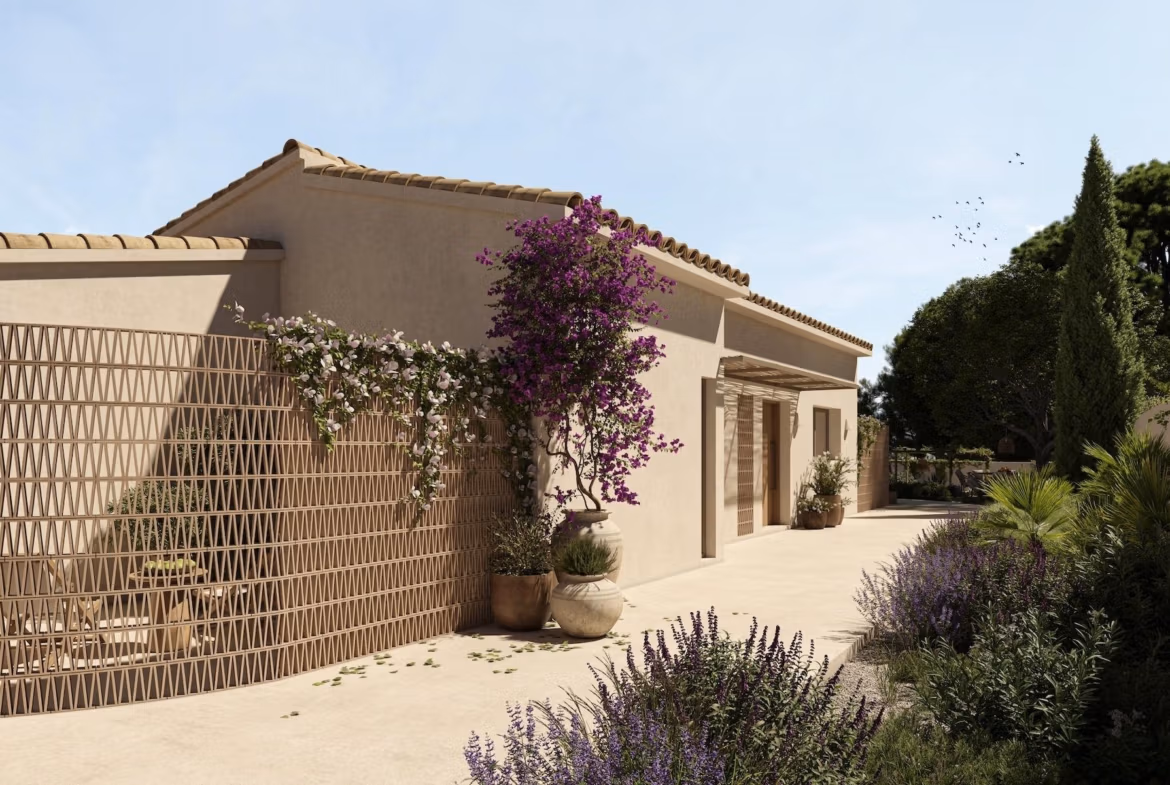 Elegant exterior of a refined single-storey villa in La Fustera, Benissa, surrounded by lush Mediterranean landscaping.