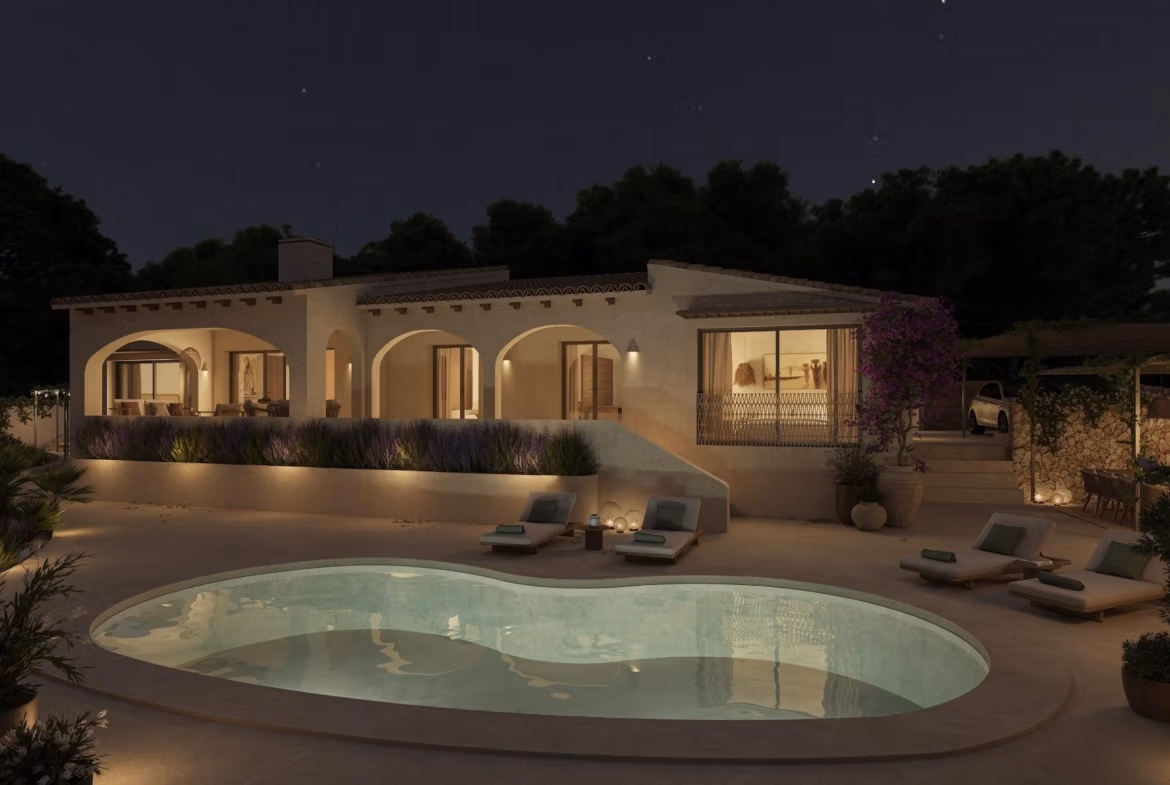 Elegant single-storey villa with softly illuminated private pool and arched terraces in tranquil La Fustera, Benissa at night.