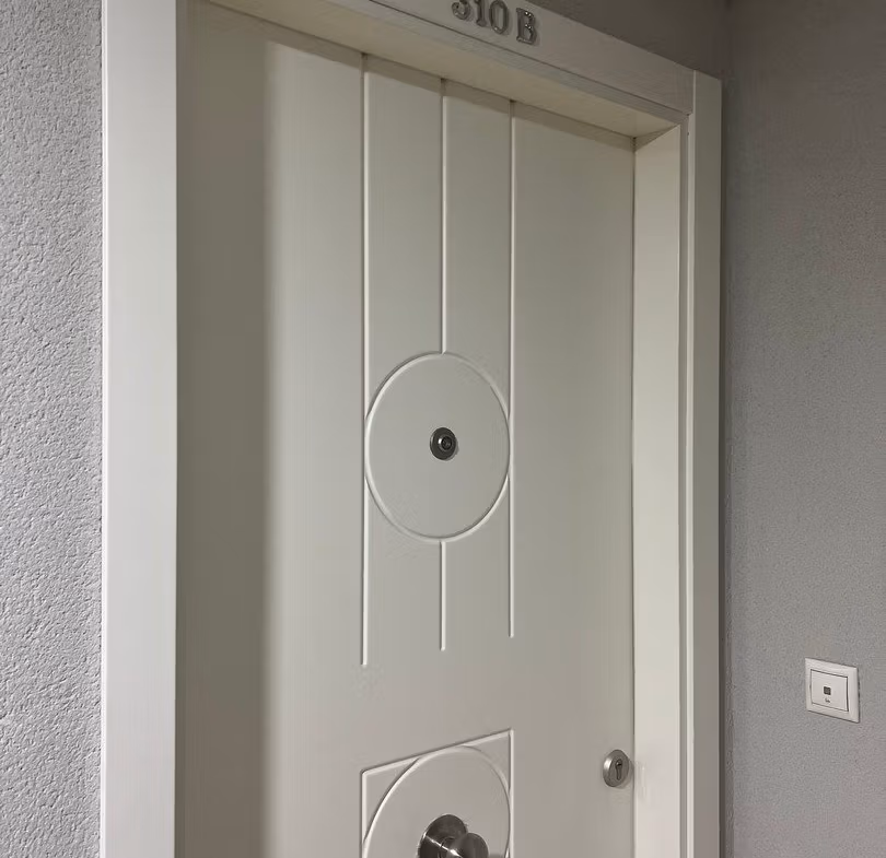 Elegant white entrance door of luxury 3 bedroom penthouse in Calpe with modern design details.
