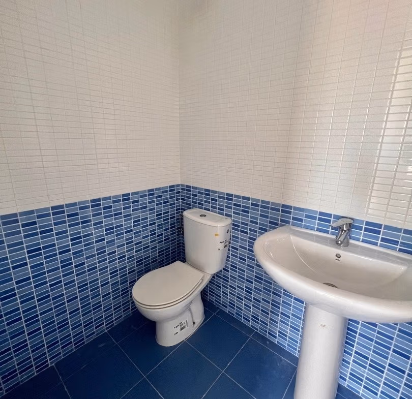 Bright, modern bathroom with elegant blue tiled flooring and walls in luxury 3-bedroom penthouse in Calpe