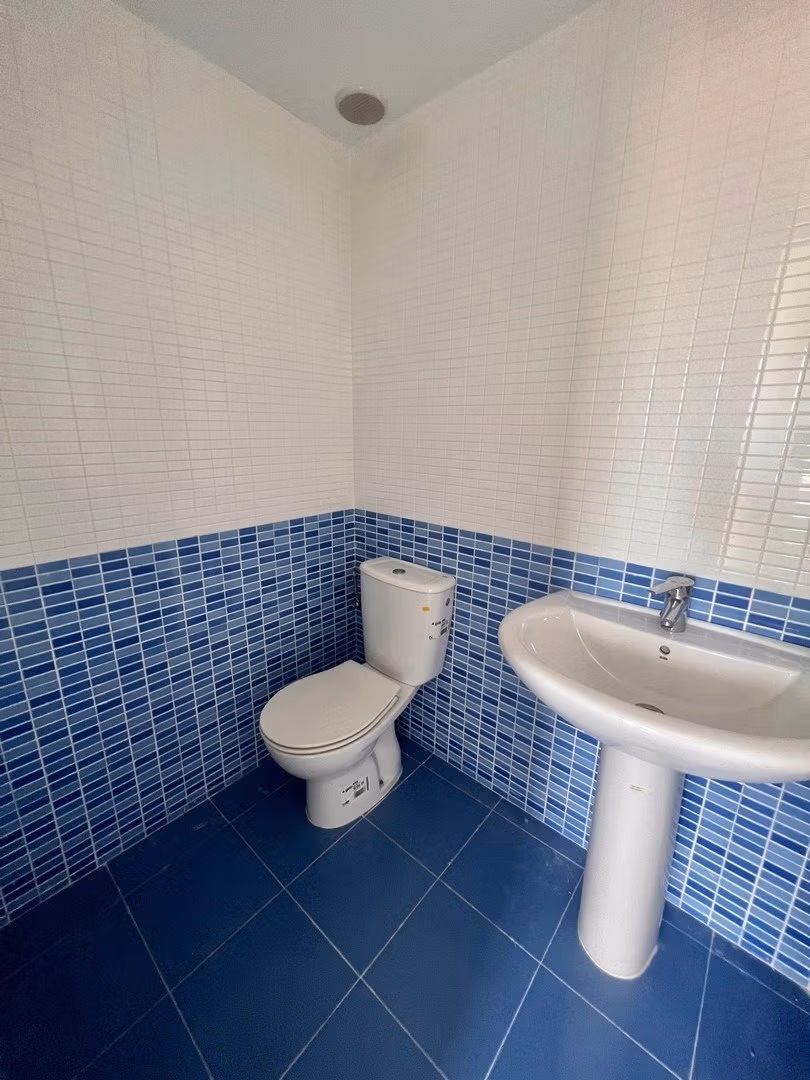 Bright, modern bathroom with elegant blue tiled flooring and walls in luxury 3-bedroom penthouse in Calpe