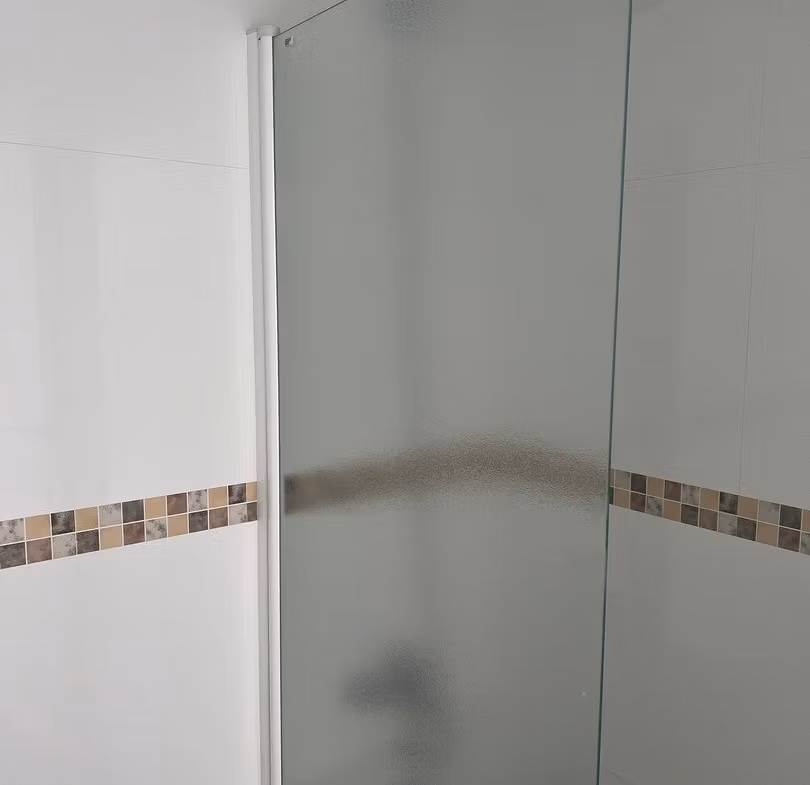 Bright modern bathroom with frosted glass shower enclosure in luxury 3 bedroom penthouse in Calpe