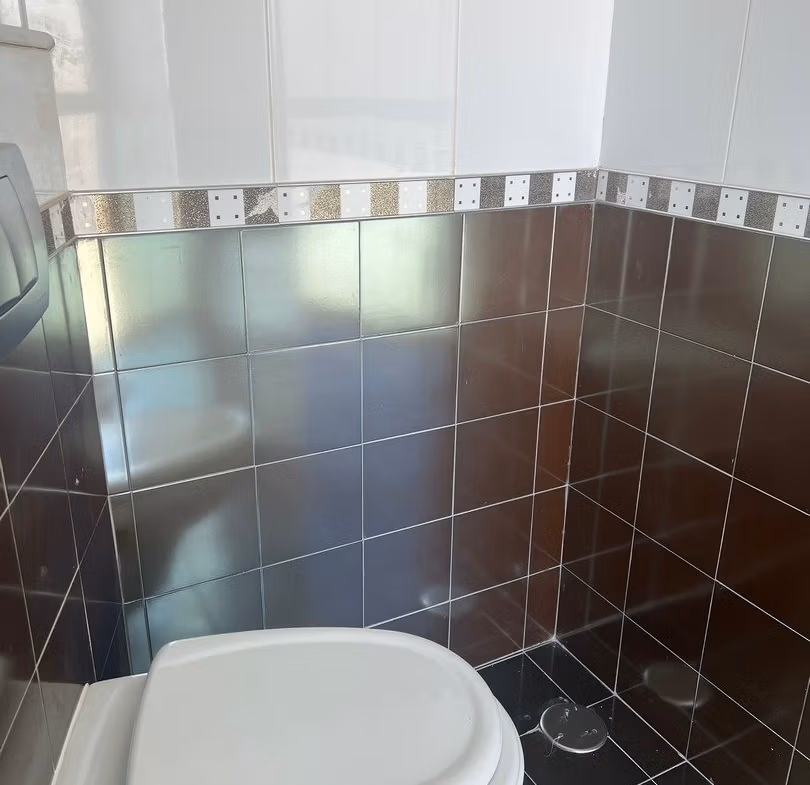 Compact modern bathroom with sleek tiled walls in luxury 3-bedroom penthouse for sale in Calpe.