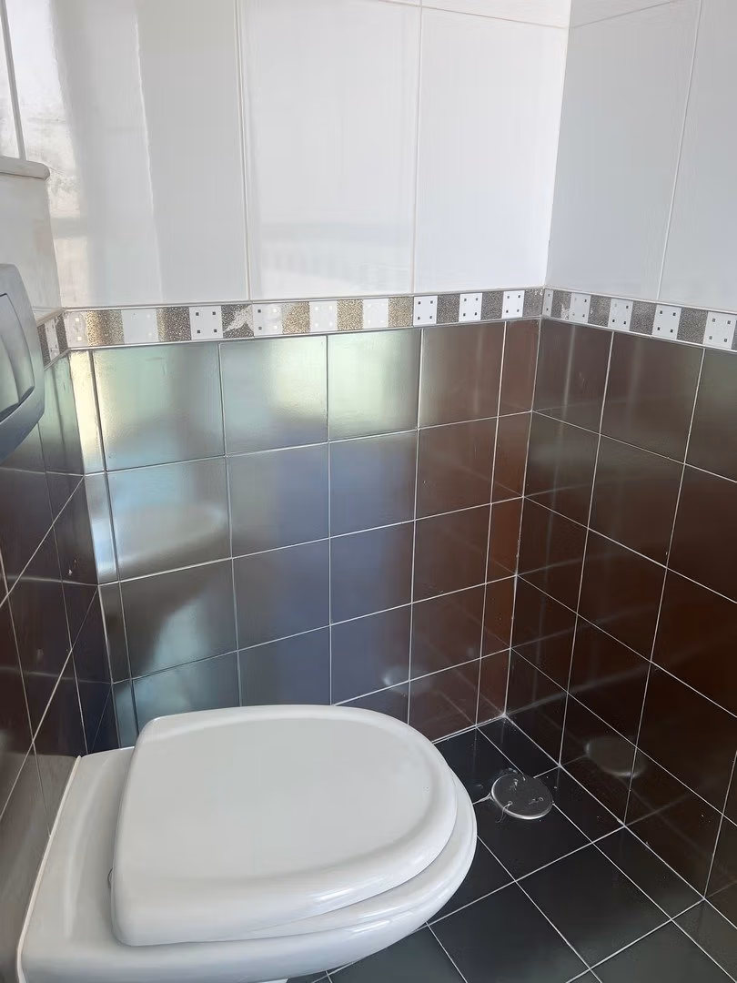 Compact modern bathroom with sleek tiled walls in luxury 3-bedroom penthouse for sale in Calpe.