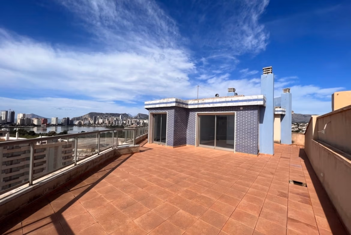 Spacious sun-drenched penthouse terrace with panoramic sea views and modern finishes in luxury 3 bedroom penthouse in Calpe.