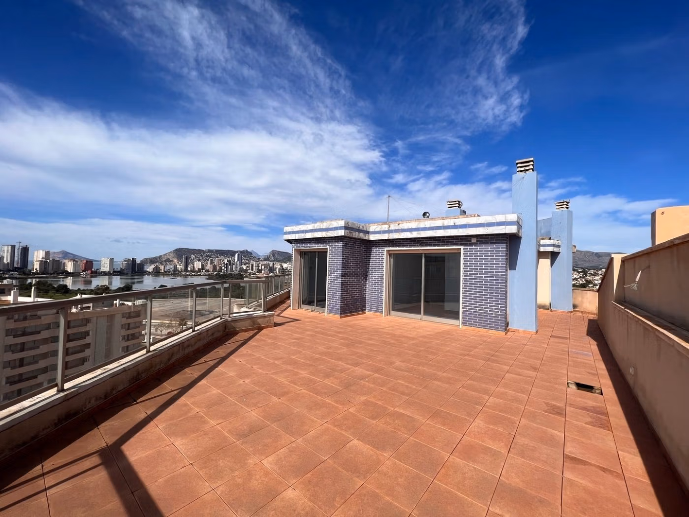 Spacious sun-drenched penthouse terrace with panoramic sea views and modern finishes in luxury 3 bedroom penthouse in Calpe.