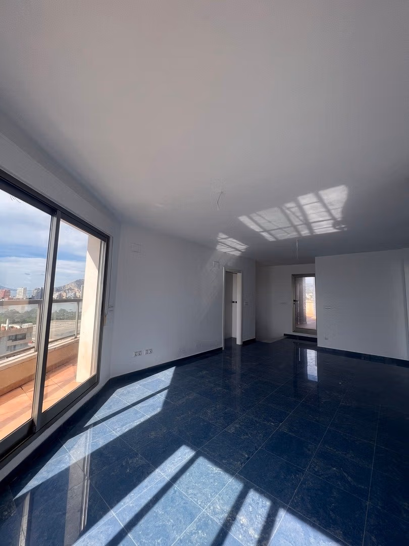 Bright, spacious living room with large glass doors and panoramic views in luxury 3-bedroom penthouse in Calpe.