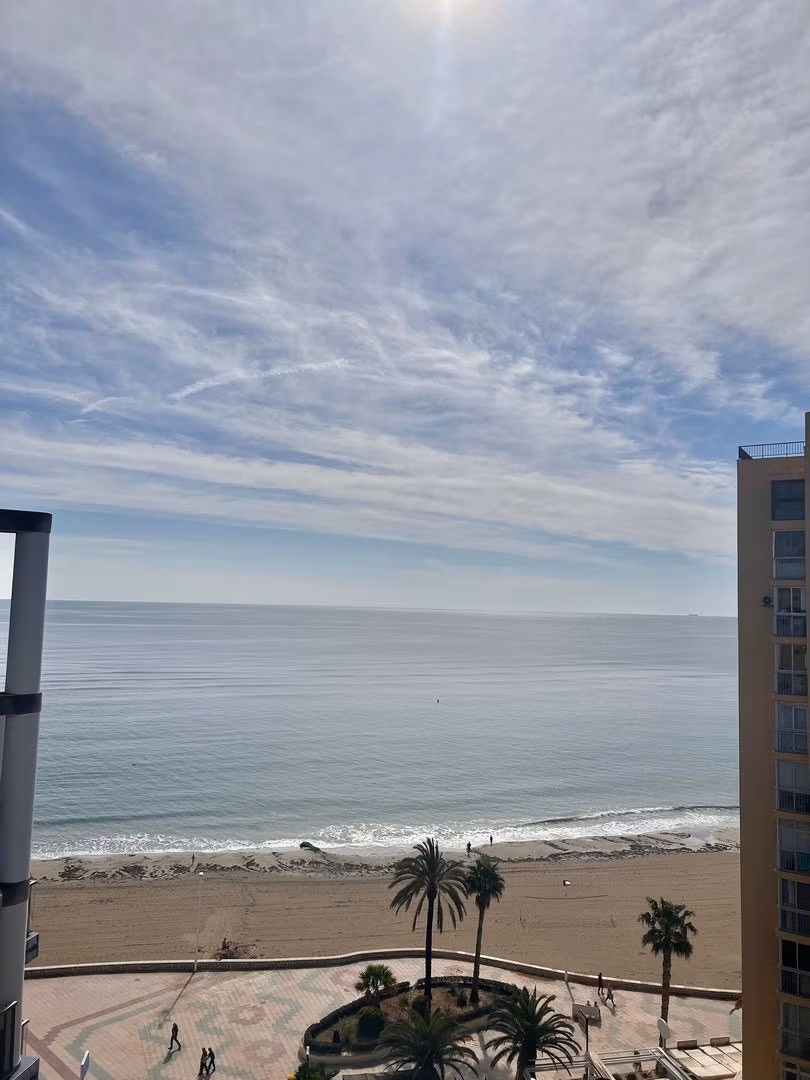 Panoramic sea view from the sun-drenched luxury 3 bedroom penthouse solarium in Calpe with pristine beachfront below.