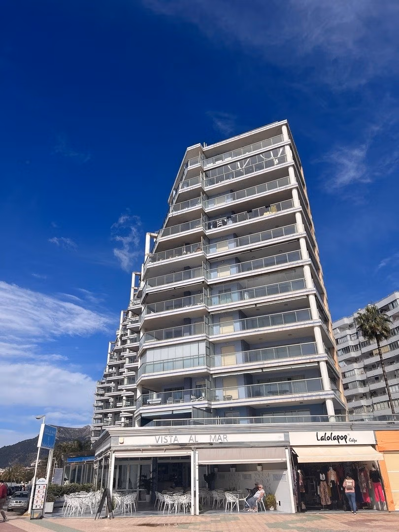 Modern luxury 3 bedroom penthouse in Calpe with panoramic sea views and spacious sunlit balconies under a bright blue sky.