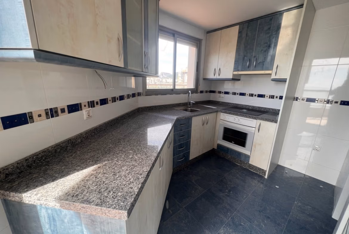 Bright, modern kitchen with granite countertops in luxury 3-bedroom penthouse for sale in Calpe.