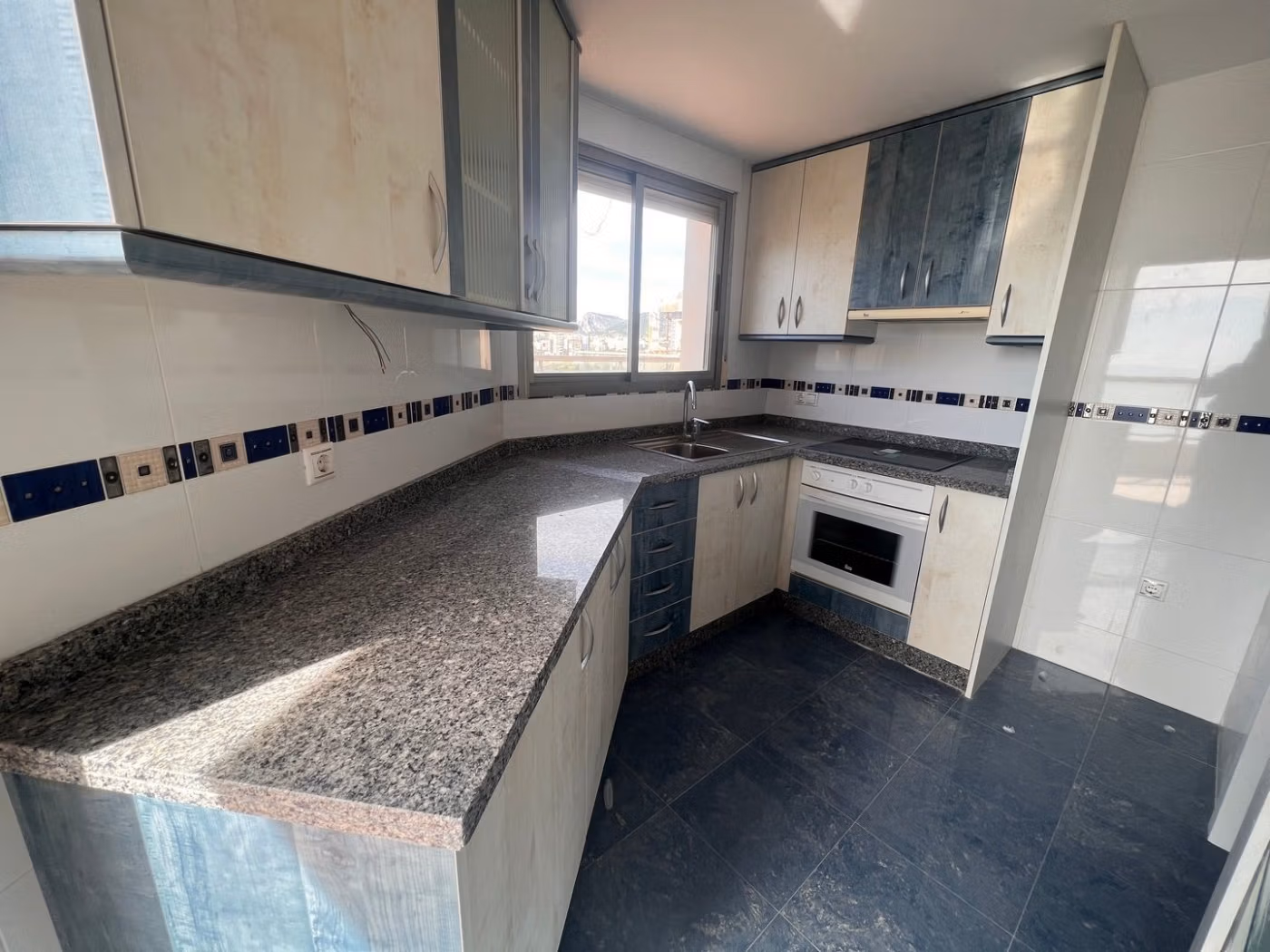 Bright, modern kitchen with granite countertops in luxury 3-bedroom penthouse for sale in Calpe.