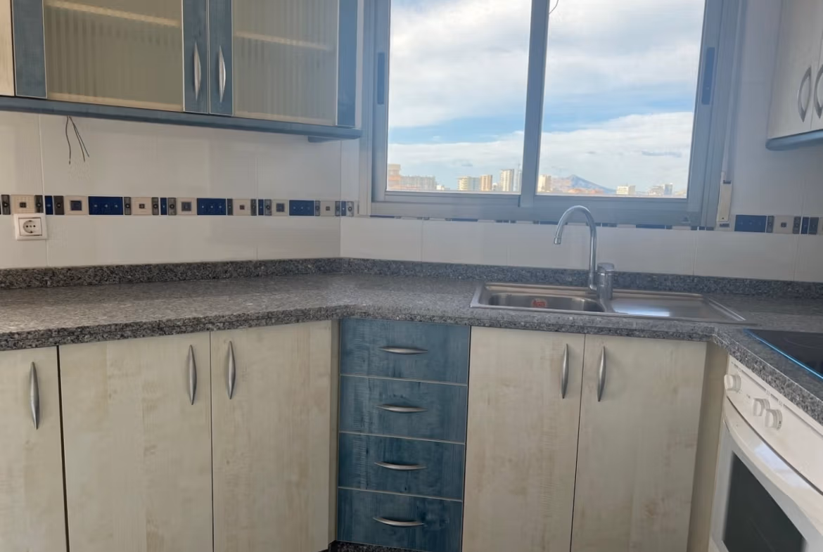 Bright, modern kitchen with granite countertops and city views in luxury 3-bedroom penthouse for sale in Calpe.