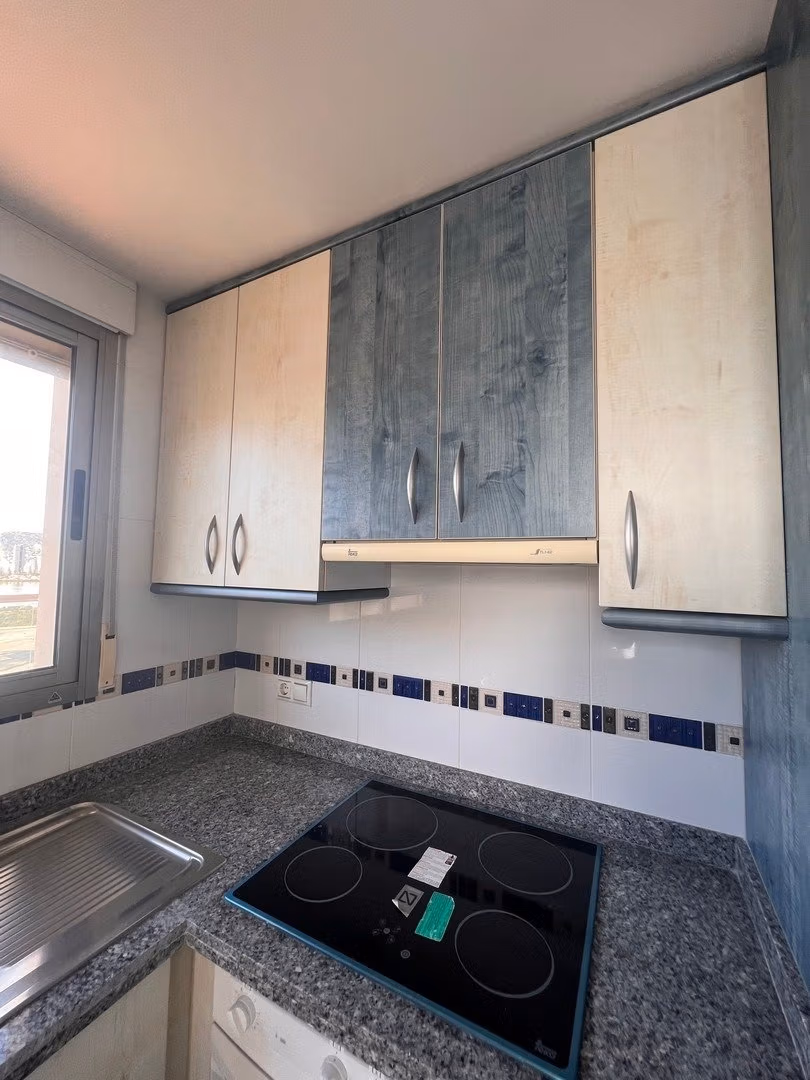 Compact modern kitchen with granite countertops in luxury 3 bedroom penthouse for sale in Calpe