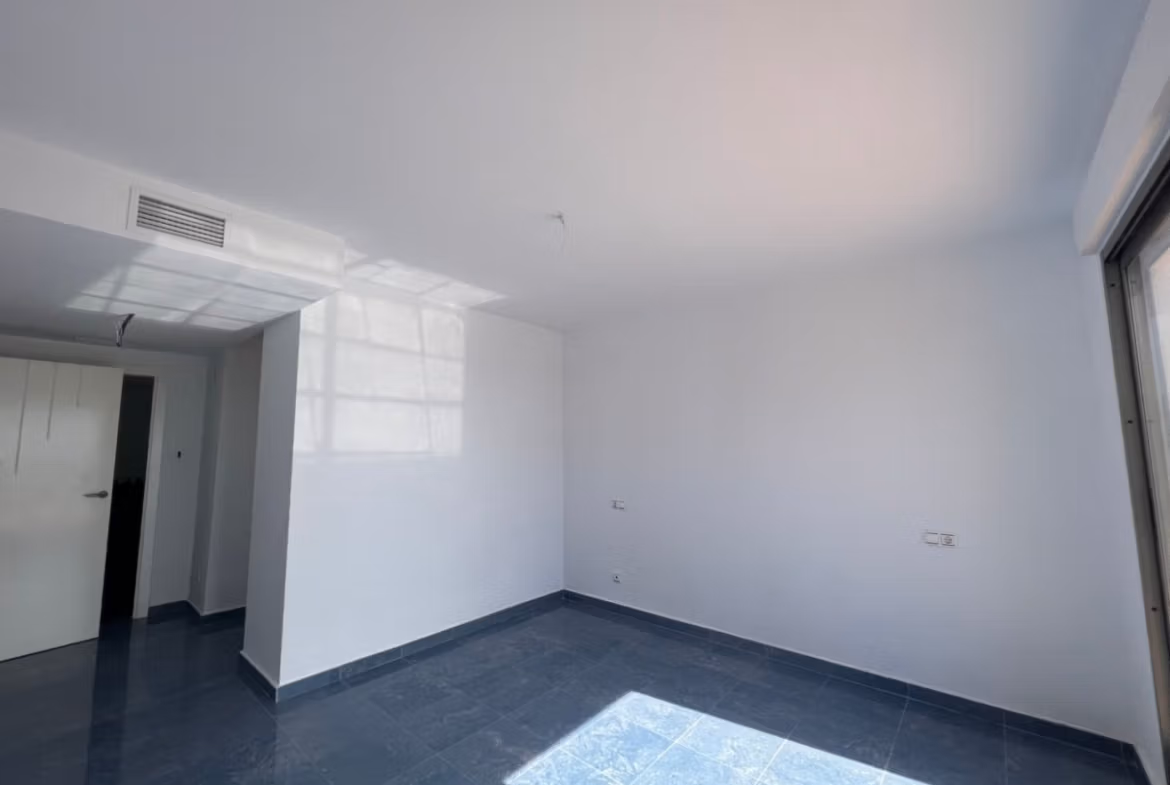 Bright, spacious bedroom with modern finishes and sleek flooring in luxury 3-bedroom penthouse in Calpe.