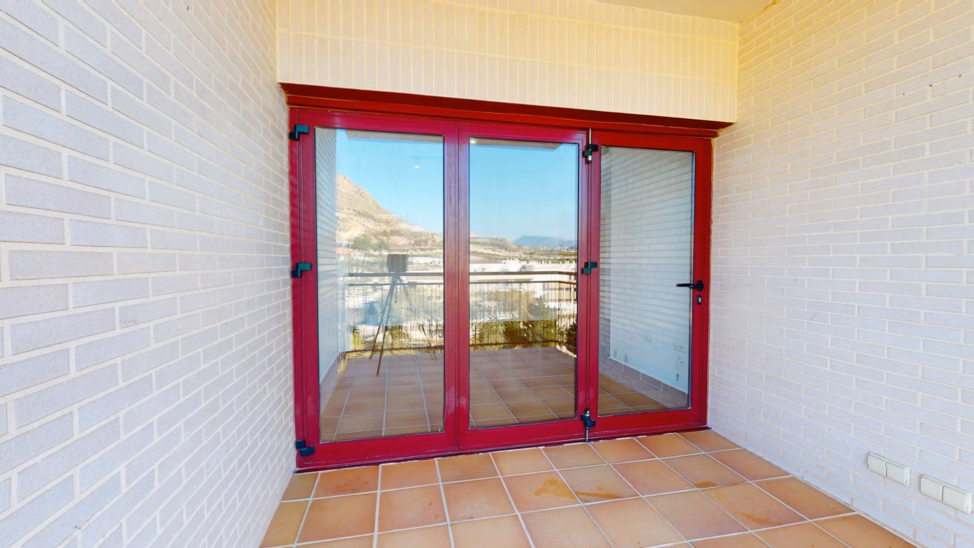 Bright sunlit terrace with terracotta tiles and panoramic mountain views in a charming 1-bedroom apartment in Villanueva del Rio Segura