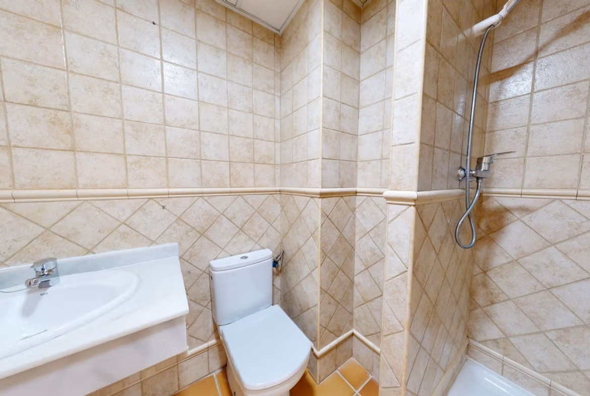 Compact modern bathroom with tiled walls and shower in a luxury 2-bedroom penthouse near Archena, Murcia.
