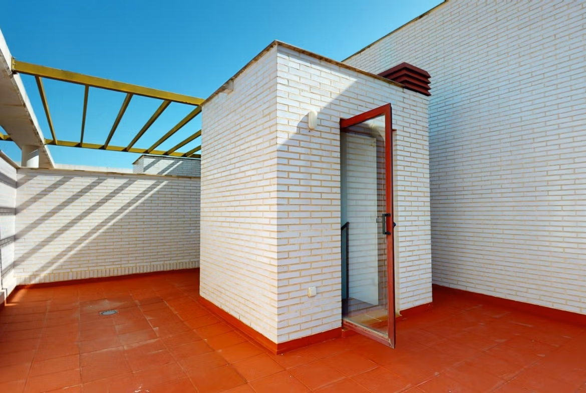 Spacious sun-drenched solarium terrace with modern white brick walls in luxury 2 bedroom penthouse near Archena, Murcia