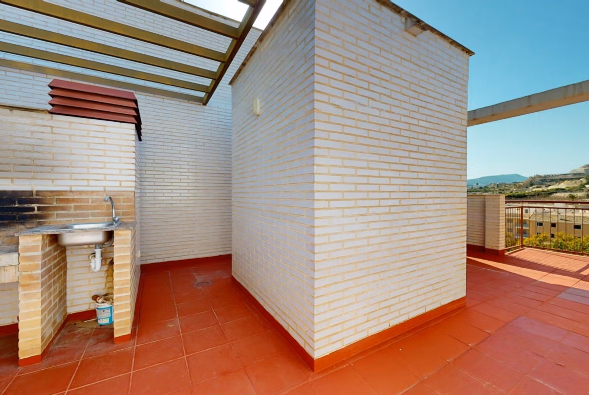 Spacious sun-drenched penthouse solarium with built-in barbecue and panoramic views near Archena, Murcia.
