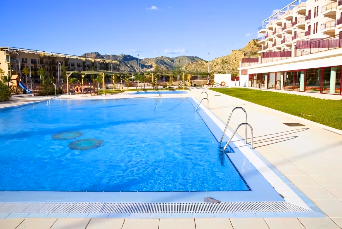Sun-drenched luxury penthouse near Archena, Murcia featuring a sparkling swimming pool with mountain views and landscaped surroundings.