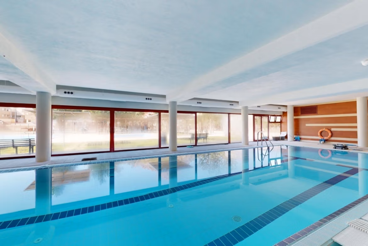 Bright indoor swimming pool with modern design in luxury penthouse near Archena, Murcia, offering serene relaxation and leisure.