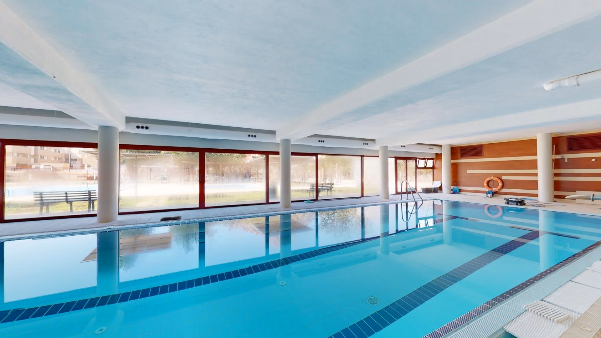 Bright indoor swimming pool with modern design in luxury penthouse near Archena, Murcia, offering serene relaxation and leisure.