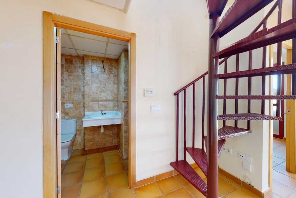 Bright key-ready penthouse near Archena, Murcia, featuring a modern tiled bathroom and elegant spiral staircase.