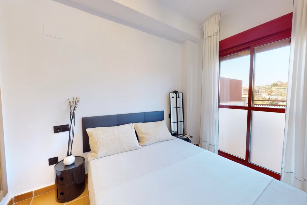 Bright and airy 1-bedroom apartment bedroom with modern decor and balcony, charmingly located in Villanueva del Rio Segura near Archena.