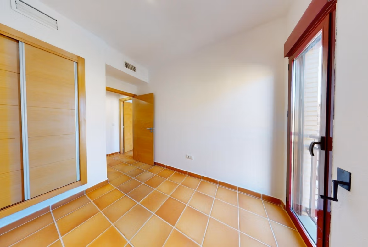 Bright spacious bedroom with terracotta floors and built-in wardrobe in luxury 2-bedroom penthouse near Archena, Murcia.