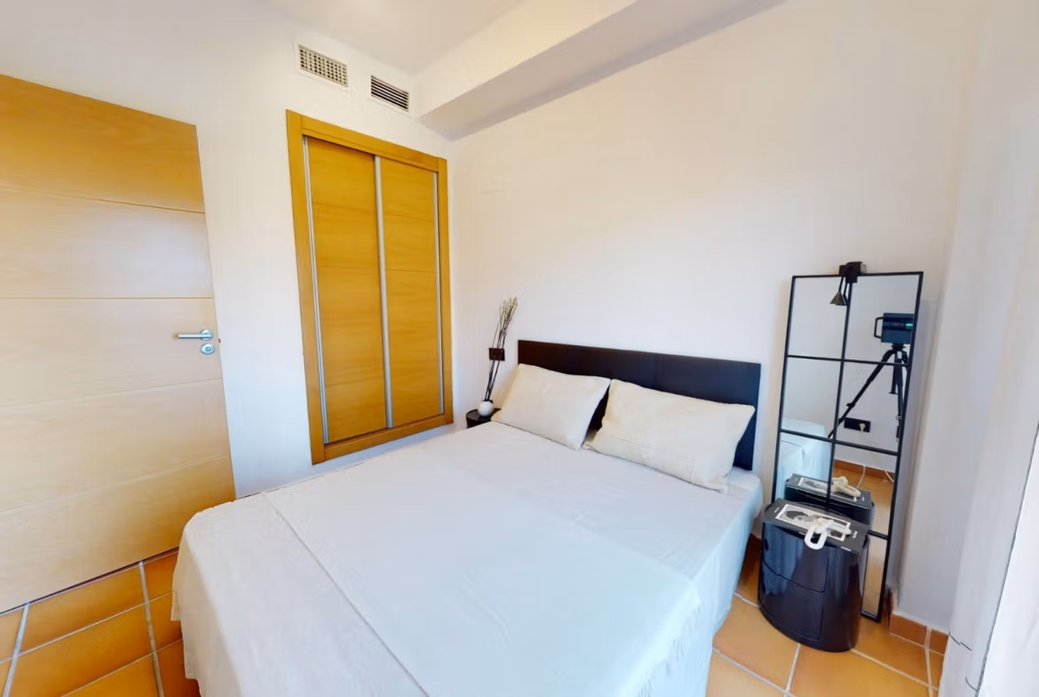 Bright and airy bedroom with modern furnishings in a charming 1-bedroom apartment for sale in Villanueva del Rio Segura near Archena.