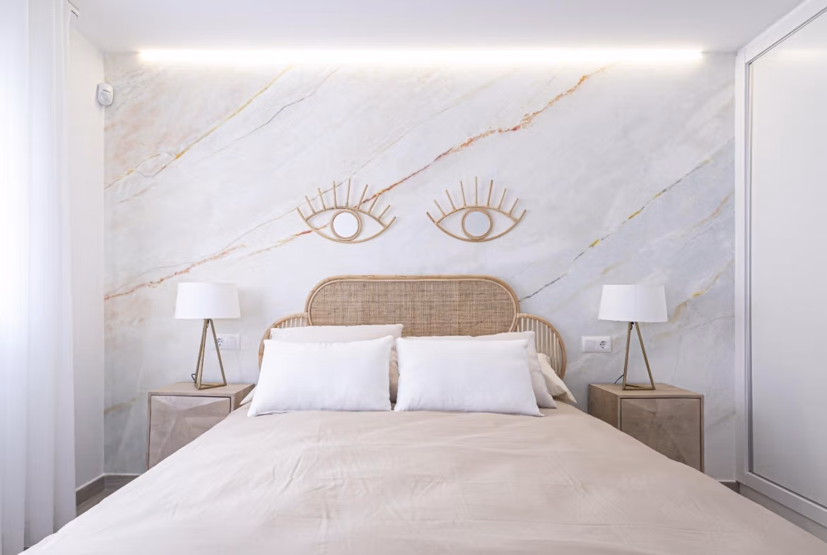 Bright, modern 2 bedroom townhouse bedroom in La Manga del Mar Menor with elegant marble accent wall and natural light