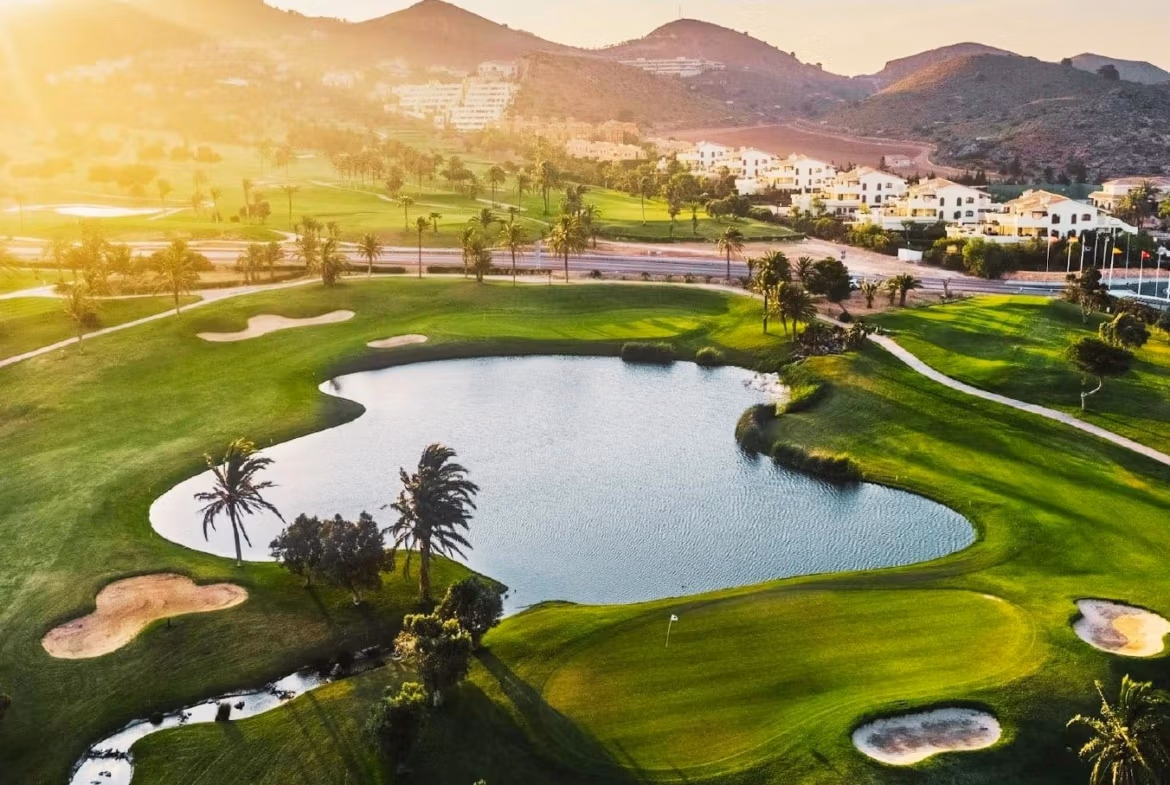 Sunlit golf course and tranquil water feature with rolling hills near La Manga del Mar Menor luxury townhouse sea views