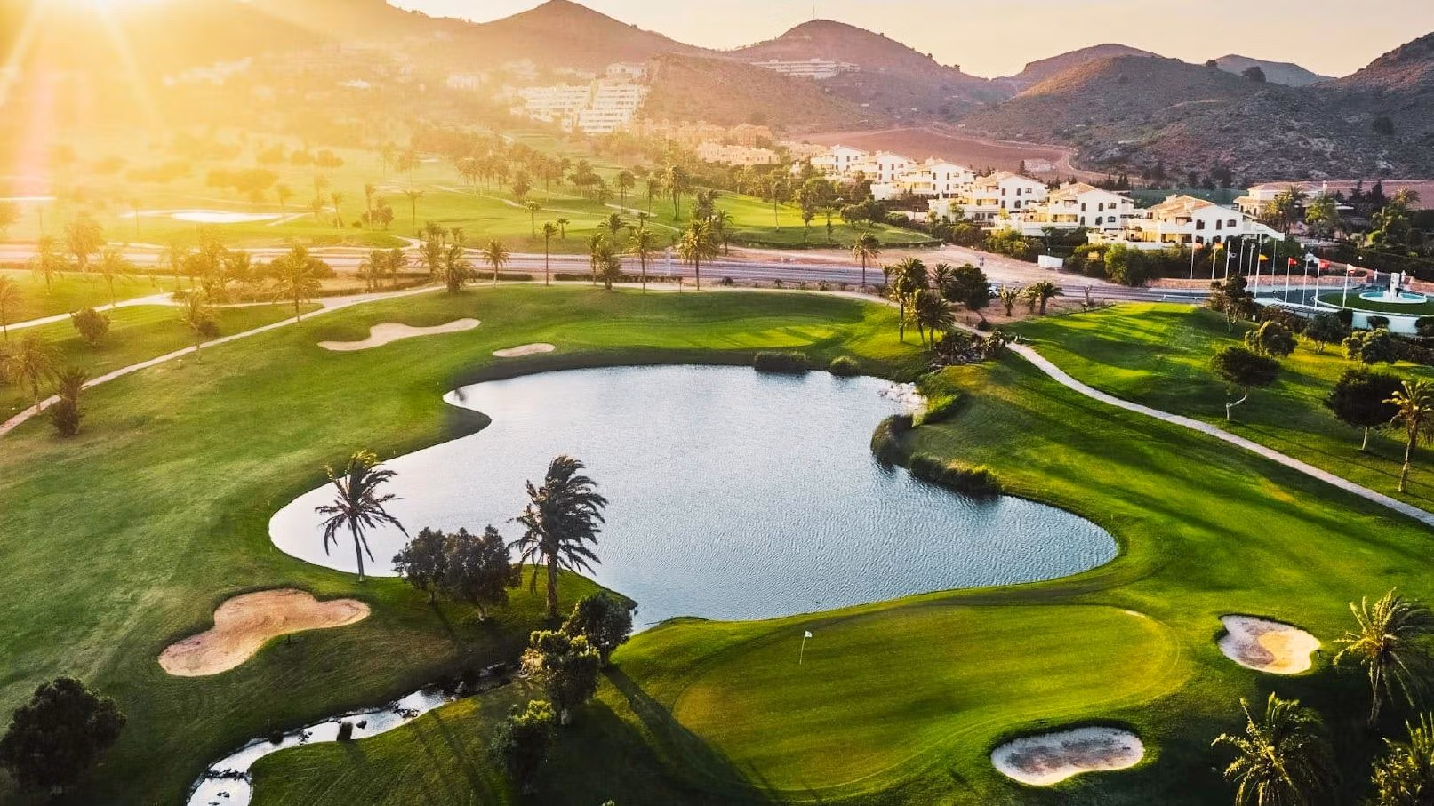 BEAUTIFUL-TOWNHOUSES-IN-LA-MANGA-22 Sunlit golf course and tranquil water feature with rolling hills near La Manga del Mar Menor luxury townhouse sea views