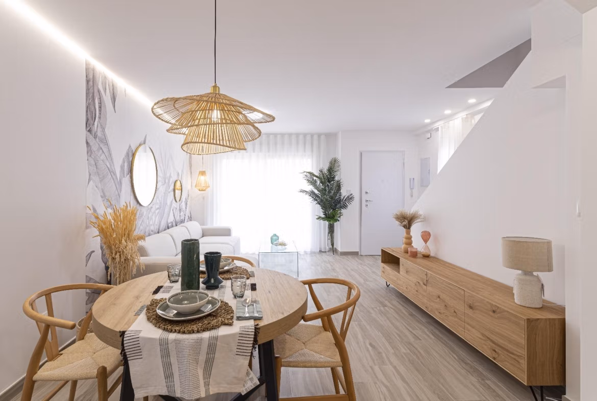 Bright open-plan dining and living area with modern wooden furniture in a spacious 3-bedroom townhouse in La Manga del Mar Menor.