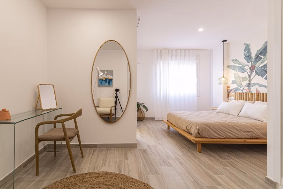 Bright modern bedroom with elegant wooden bed and artistic wall mural in spacious 3-bedroom townhouse, La Manga del Mar Menor