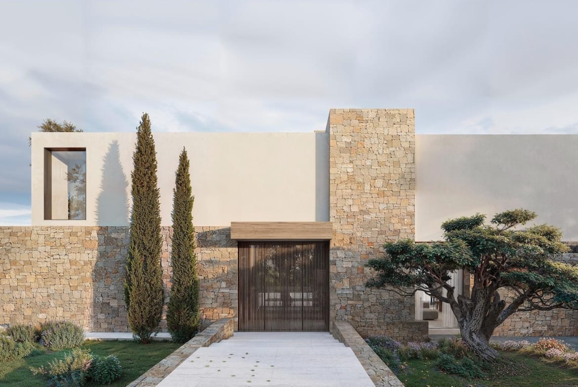 Modern architect-designed villa exterior in La Fustera, Benissa, featuring textured stone walls and minimalist landscaping.