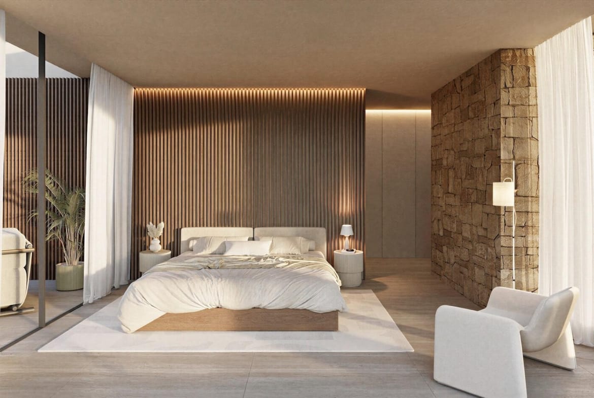 Elegant sunlit bedroom with floor-to-ceiling curtains, textured stone wall in architect-designed 4-bedroom villa in La Fustera, Benissa.