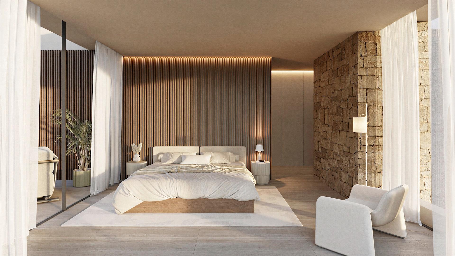 Elegant sunlit bedroom with floor-to-ceiling curtains, textured stone wall in architect-designed 4-bedroom villa in La Fustera, Benissa.