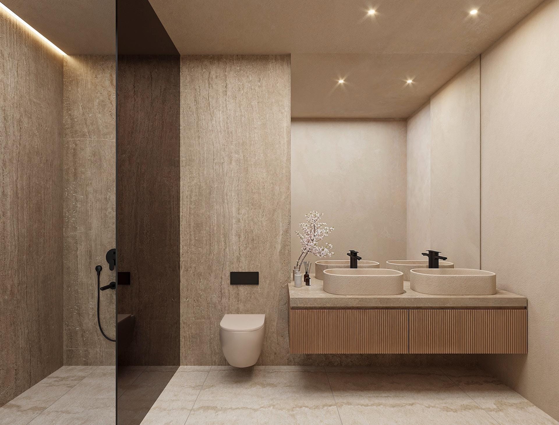 Elegant, minimalist bathroom with stone finishes and double sinks in architect-designed 4-bedroom villa in La Fustera, Benissa.