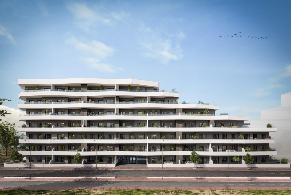 Modern multi-story building with spacious terraces, home to new 2-bedroom ground floor apartments in sunny San Miguel de Salinas.