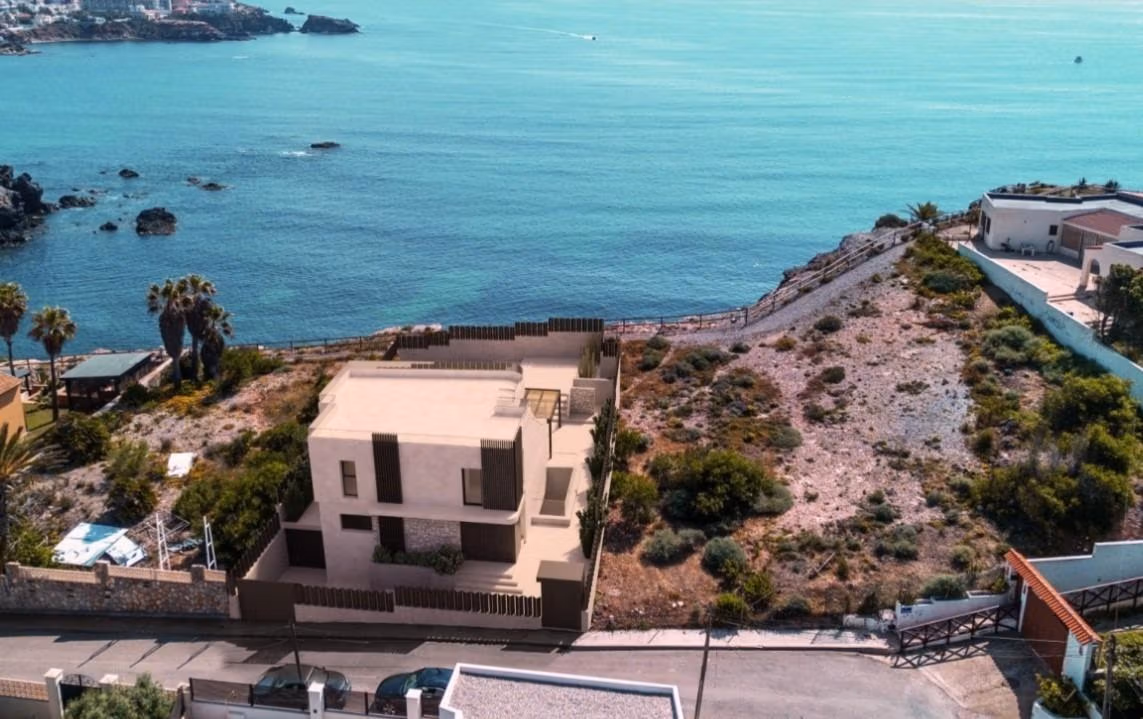 Modern frontline 3-bedroom villa in Cabo de Palos with rooftop solarium overlooking tranquil sea views and natural surroundings.