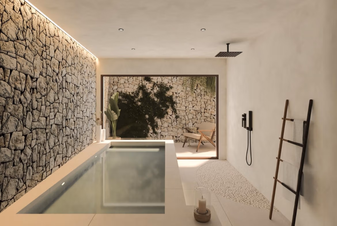 Modern indoor plunge pool with textured stone wall and calming natural light in a frontline 3-bedroom villa in Cabo de Palos