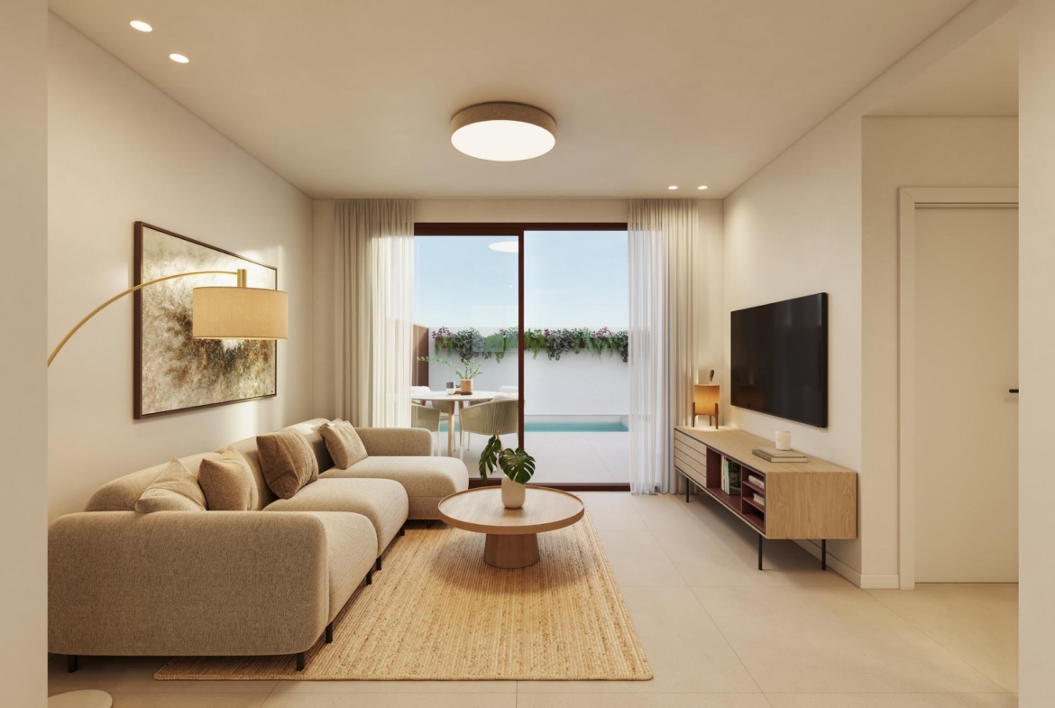 Bright, modern living room with elegant sofa and TV, opening to a private pool terrace in exclusive San Pedro del Pinatar bungalows.