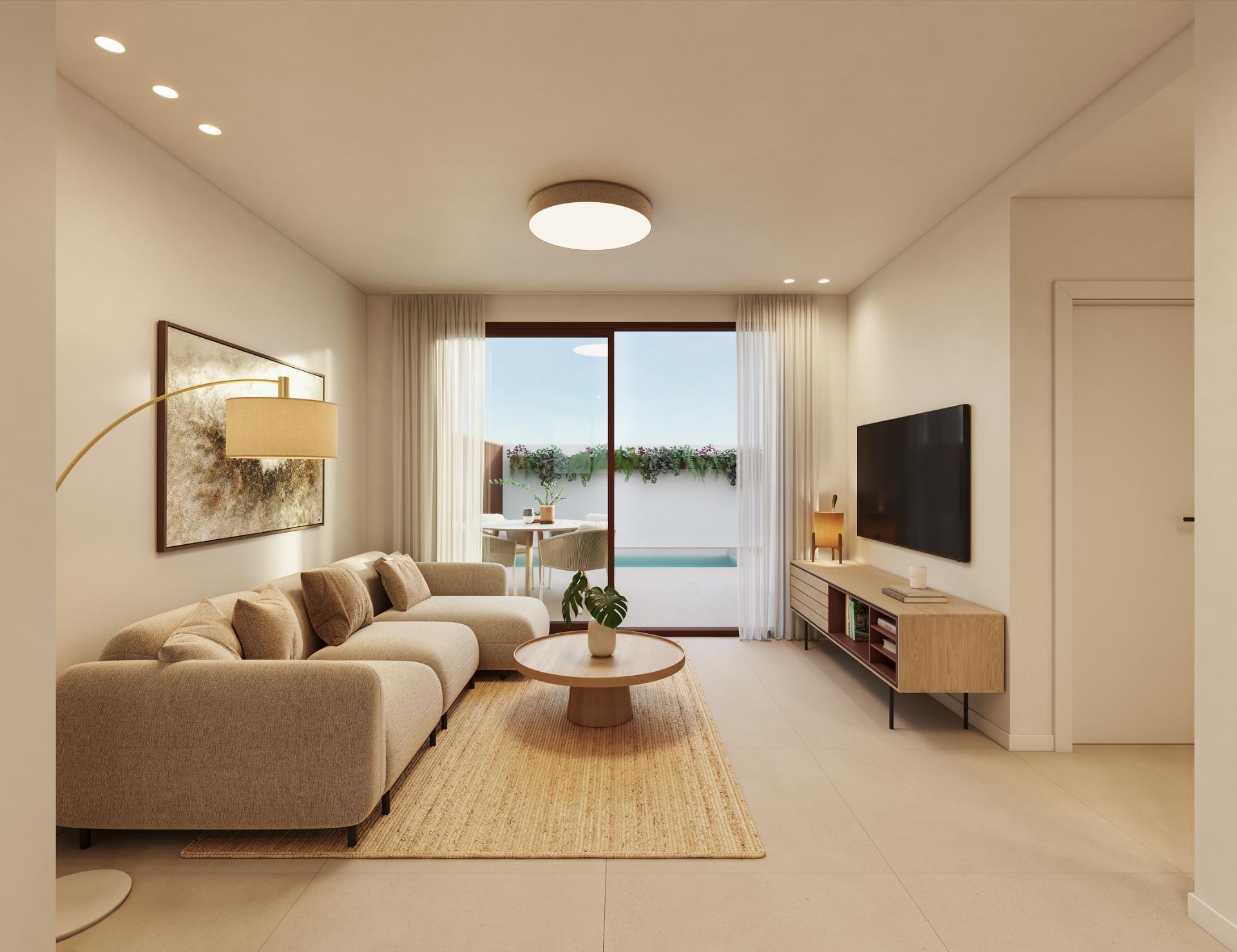 Bright, modern living room with elegant sofa and TV, opening to a private pool terrace in exclusive San Pedro del Pinatar bungalows.