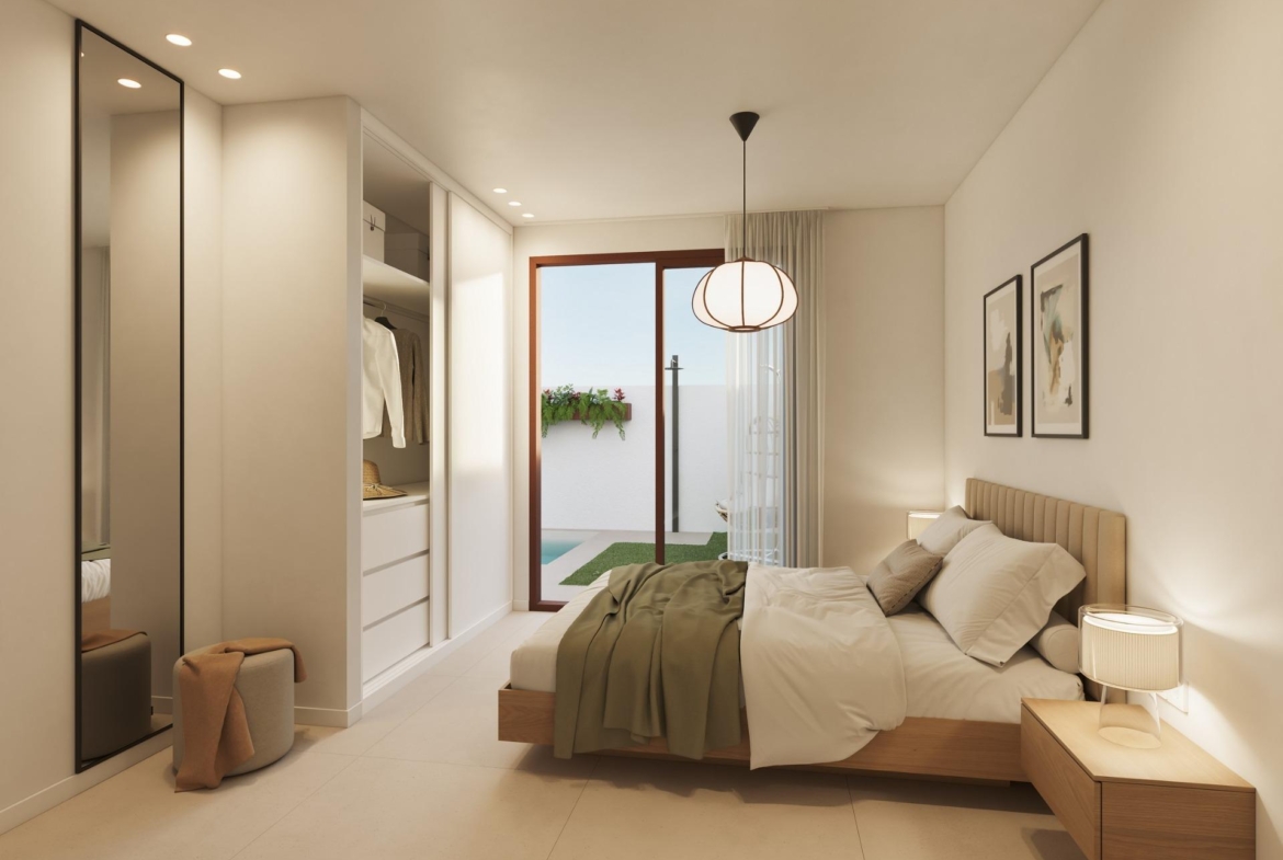 Bright, elegant bedroom in exclusive San Pedro del Pinatar bungalow with modern furnishings and access to a private sunlit terrace.