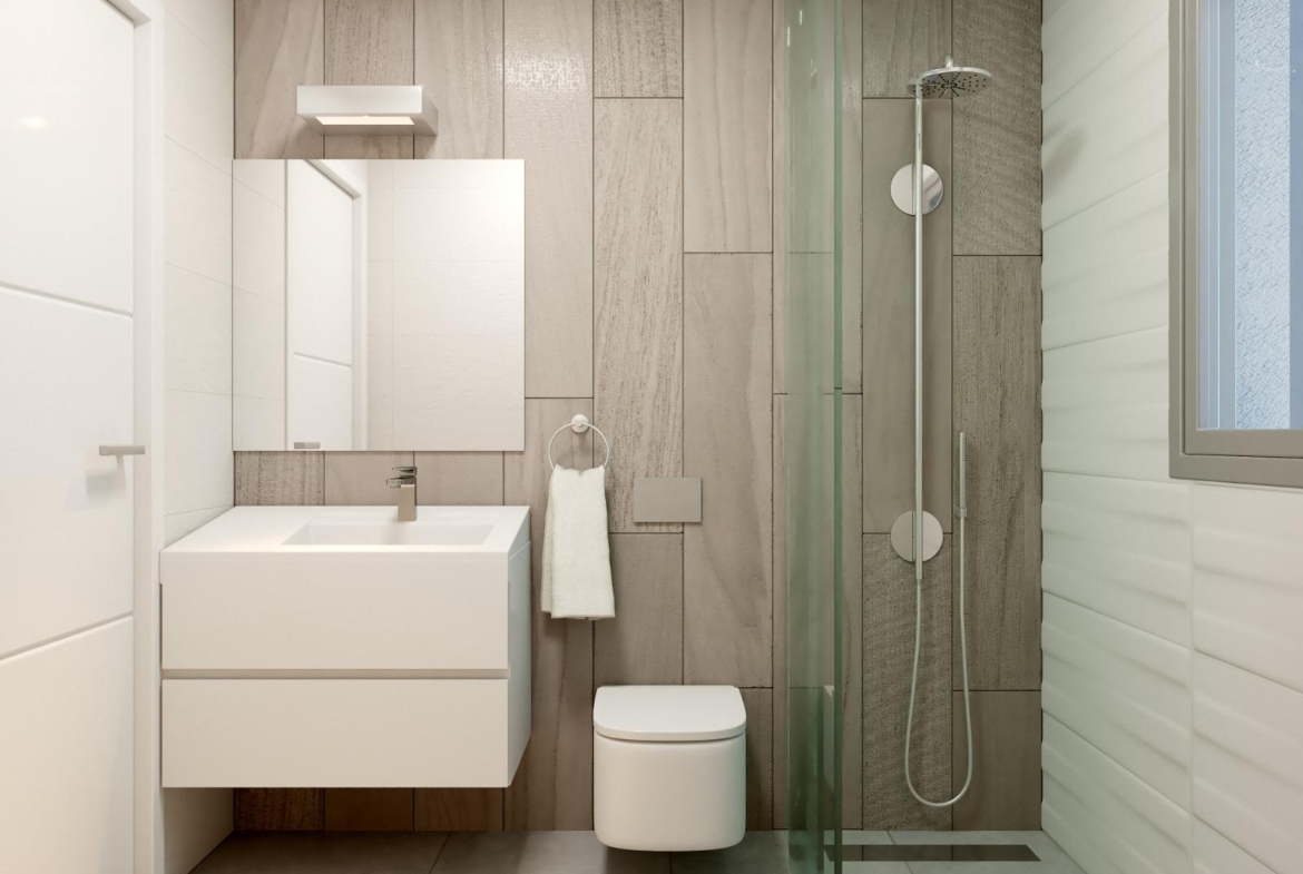 Bright modern bathroom with sleek fixtures and glass shower in a new 2-bedroom townhouse in Orihuela Costa near the beach