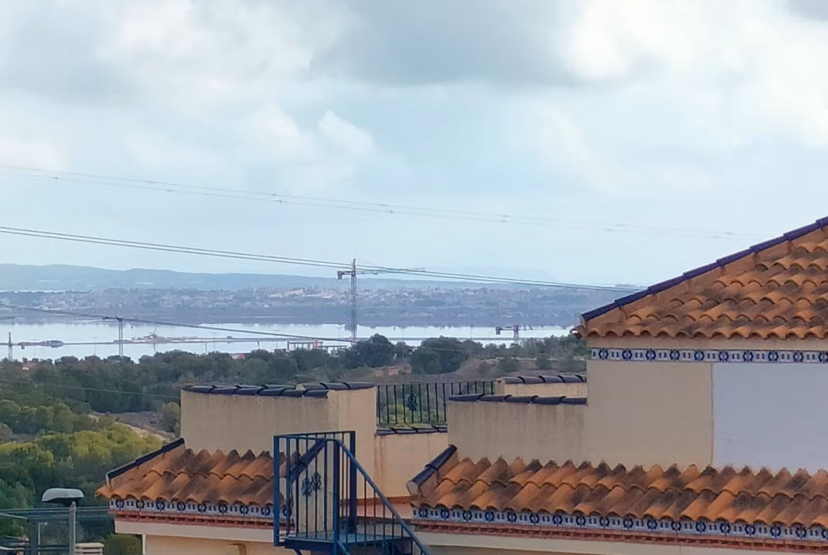 Terracotta-roofed modern 2-bedroom townhouse with spacious terraces and panoramic coastal views in Orihuela Costa near the beach.