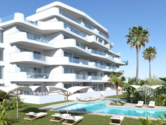 Modern stylish new build 2-bedroom tourist apartment in Mil Palmeras with spacious terraces and a landscaped pool area surrounded by palm trees.