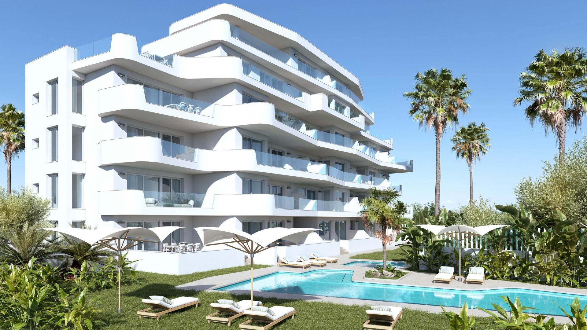 Modern stylish new build 2-bedroom tourist apartment in Mil Palmeras with spacious terraces and a landscaped pool area surrounded by palm trees.
