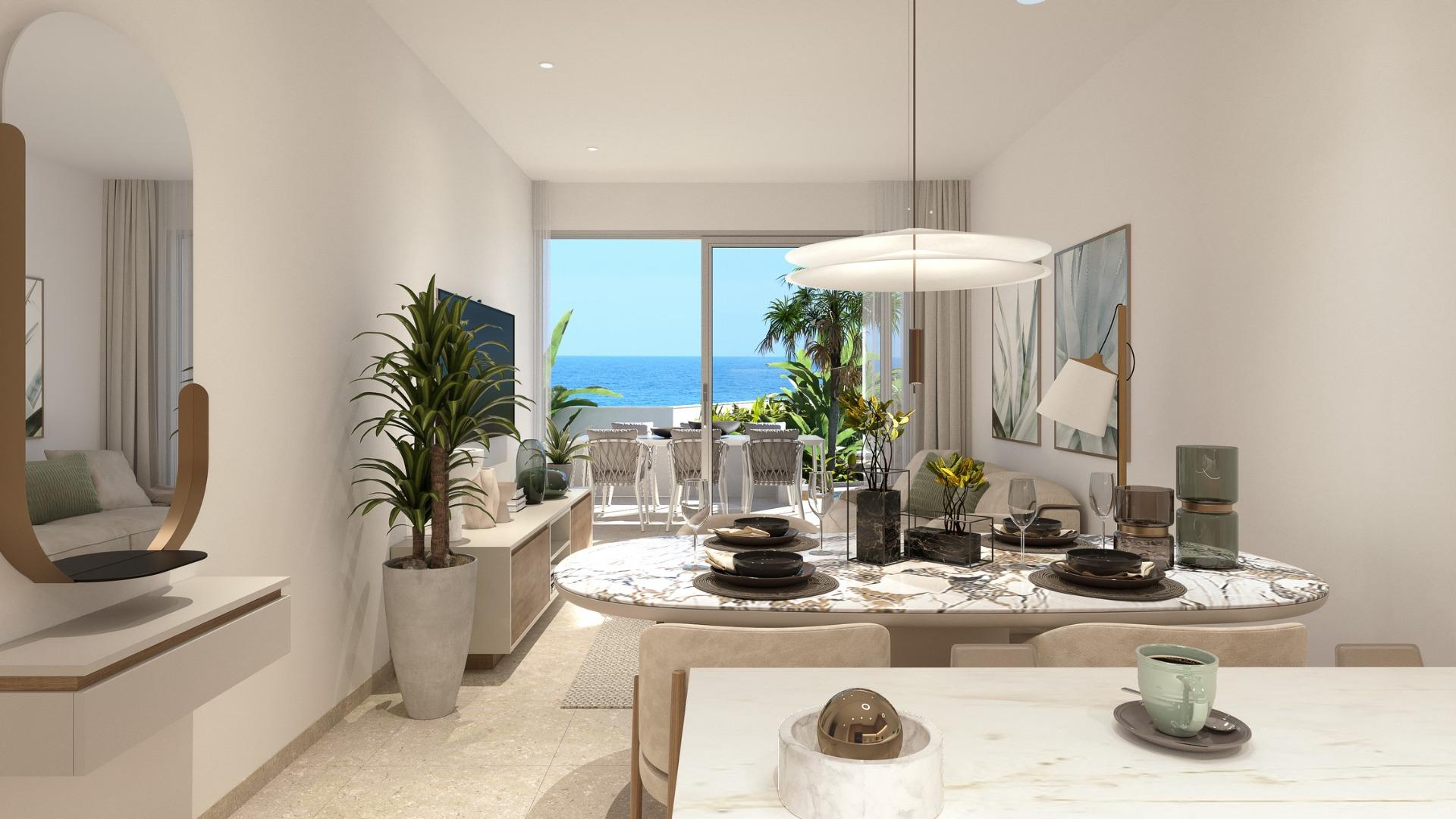 Bright open-plan living and dining area in a modern 2-bedroom ground floor apartment in Mil Palmeras, sea views visible through sliding doors.