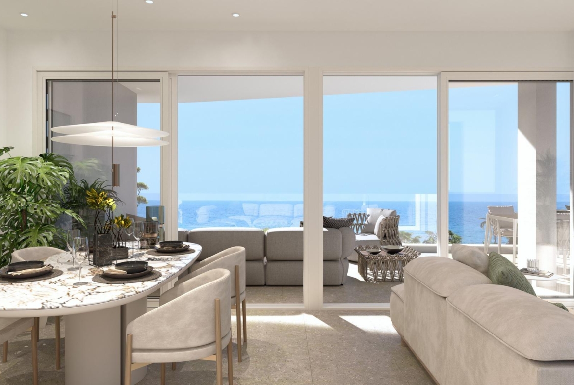 Sun-drenched open-plan living and dining area with modern furnishings and panoramic sea views in Mil Palmeras 2-bedroom penthouse.